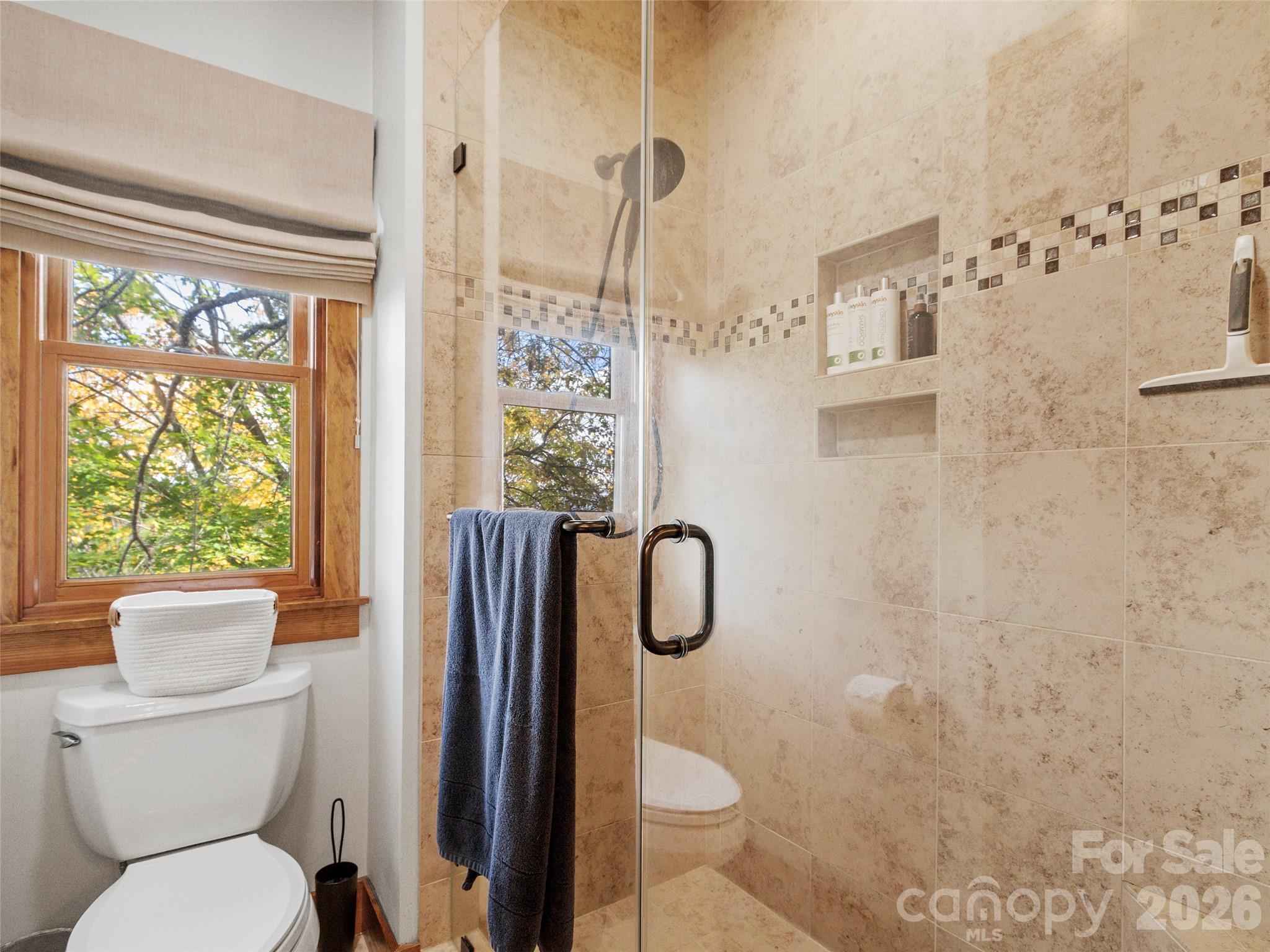 80 Slickrock Road, Unit A4 Burnsville, NC 28714 - Photo 20 of 30 a bathroom with a toilet sink and shower