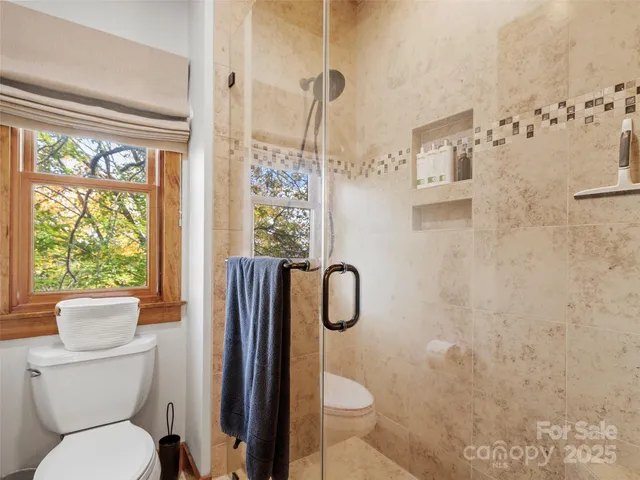 a bathroom with a toilet sink and shower