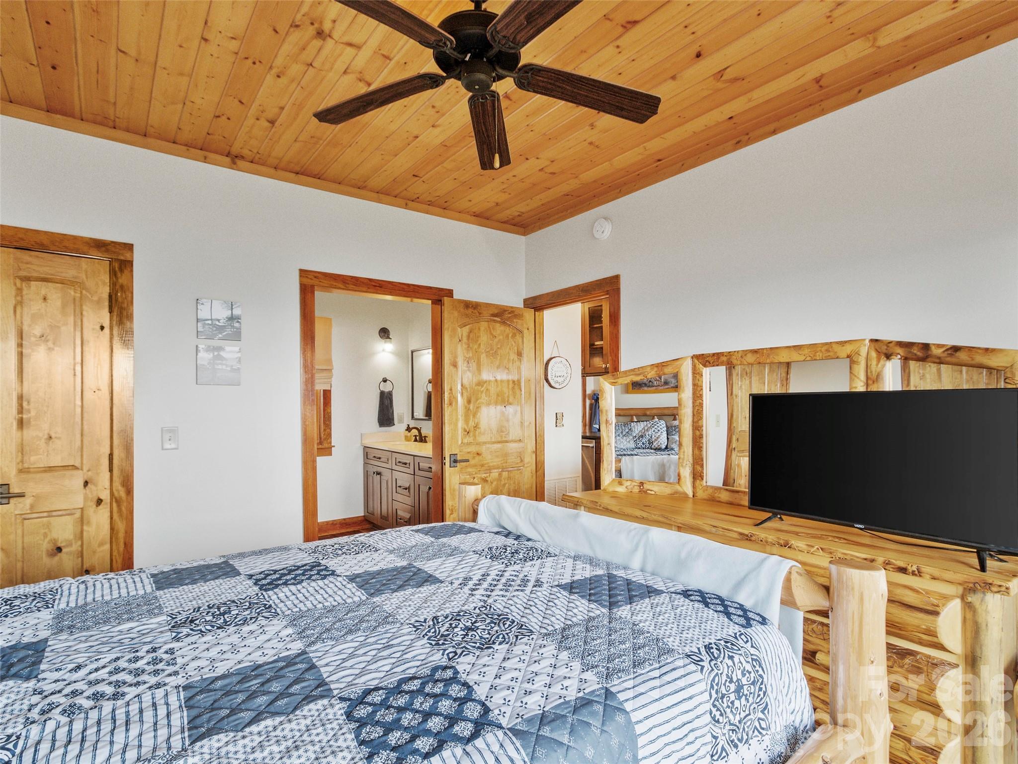 80 Slickrock Road, Unit A4 Burnsville, NC 28714 - Photo 21 of 30 a bedroom with a bed and a flat screen tv