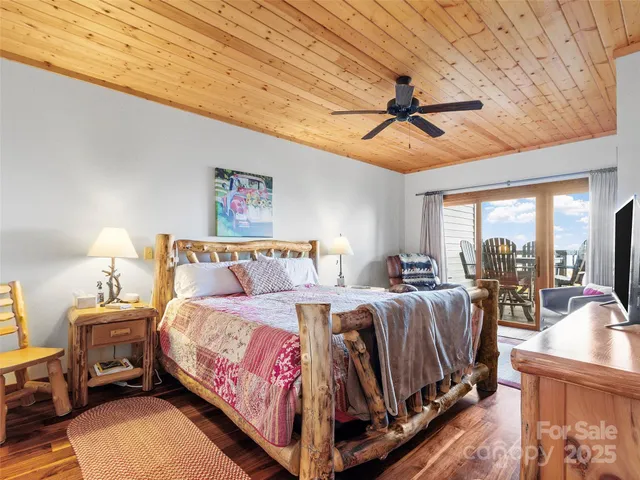 a bed room with a bed couch and a ceiling fan