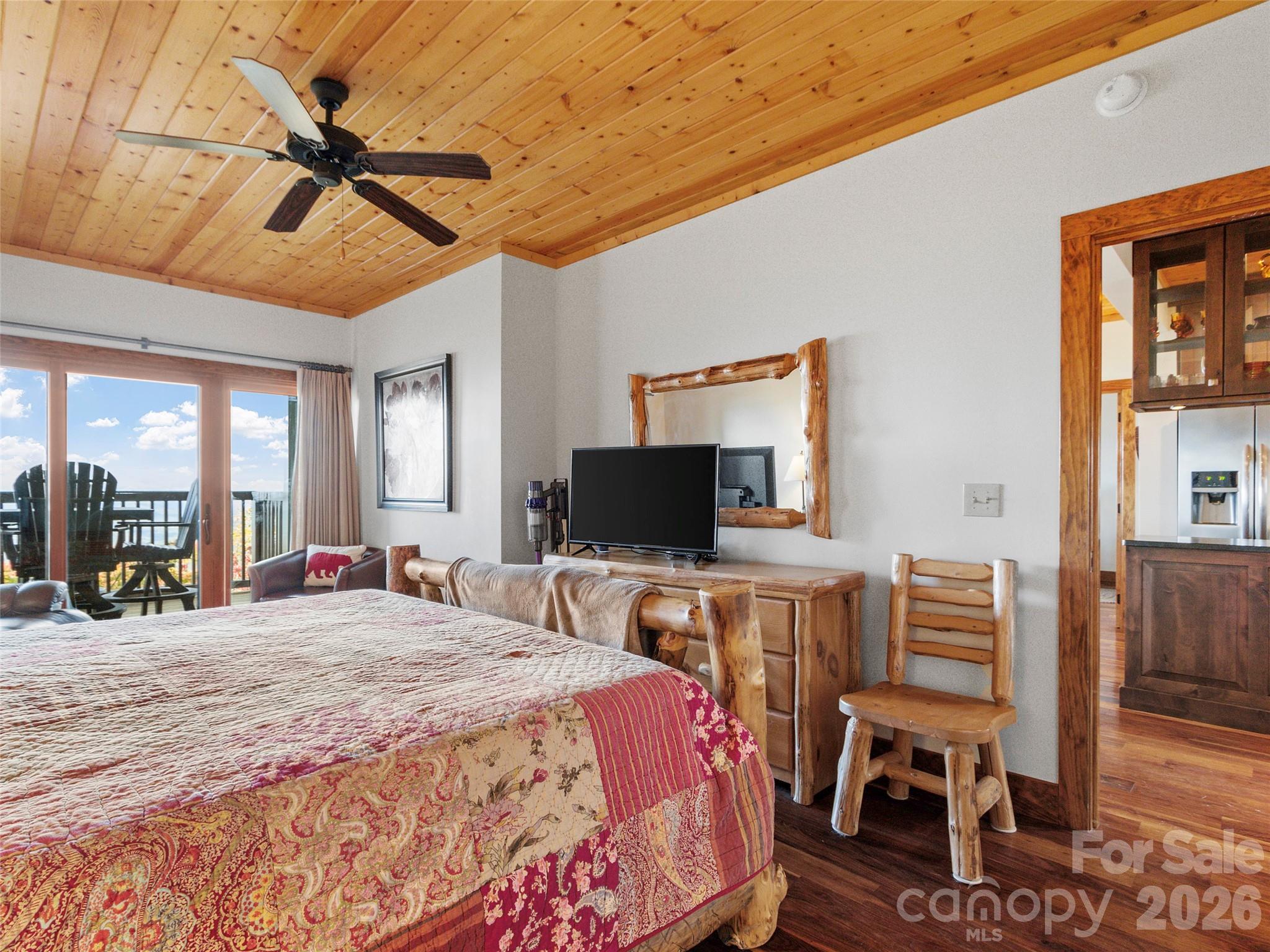 80 Slickrock Road, Unit A4 Burnsville, NC 28714 - Photo 24 of 30 a bedroom with a bed and a flat screen tv