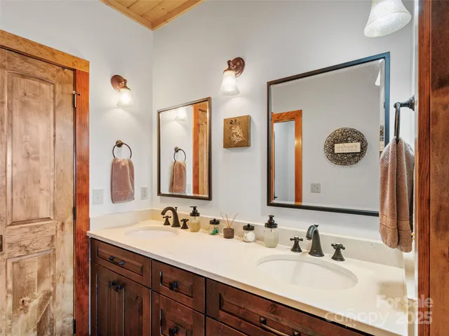 a bathroom with a double vanity sink and a mirror