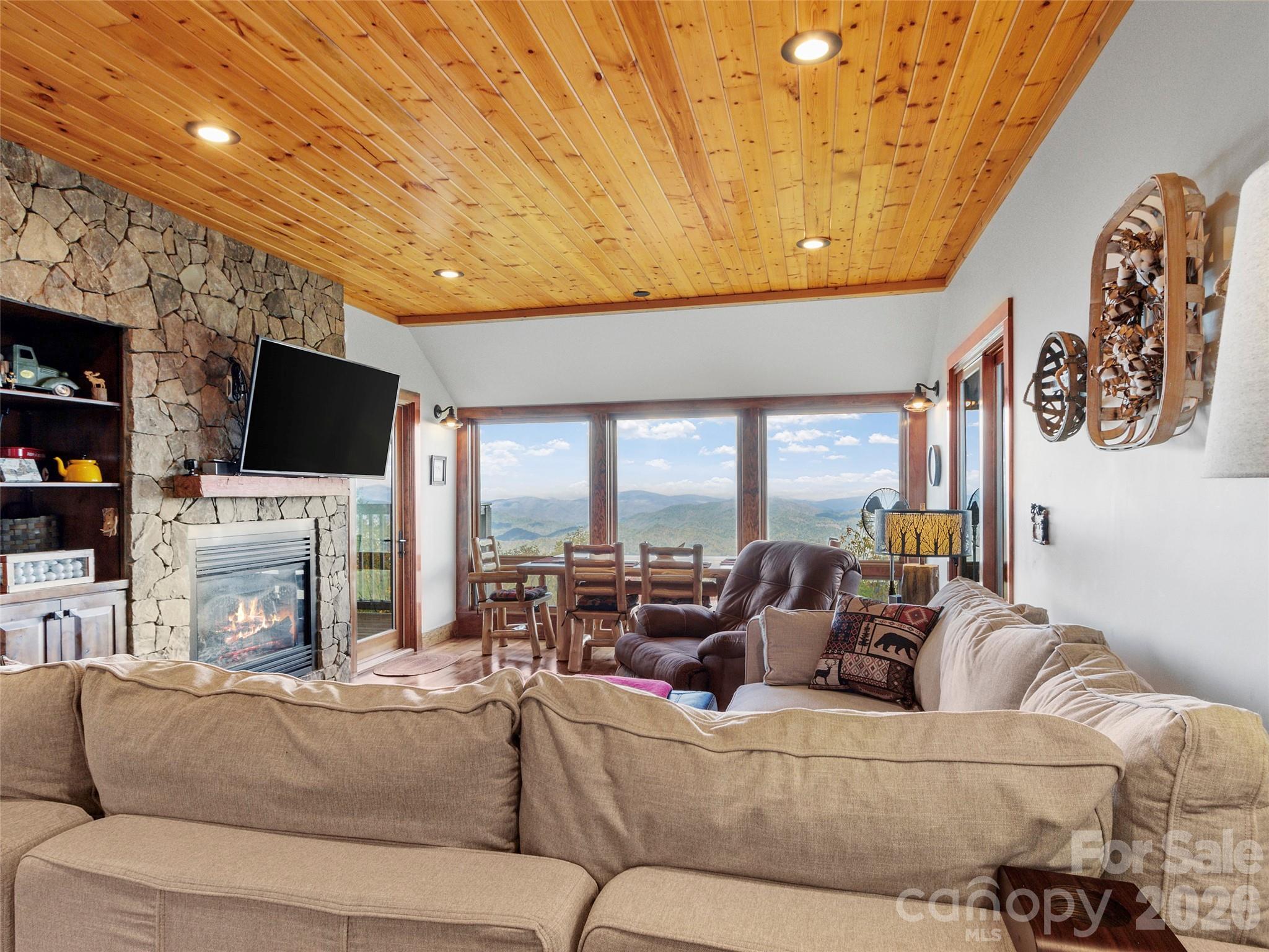 80 Slickrock Road, Unit A4 Burnsville, NC 28714 - Photo 6 of 30 a living room with fireplace furniture and a flat screen tv