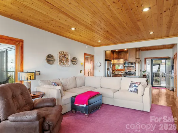 a living room with furniture and kitchen view