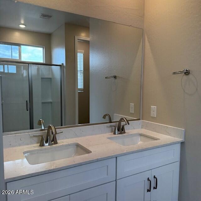 24194 West Atlantis Way Buckeye, AZ 85326 - Photo 6 of 9 a bathroom with a sink and a mirror