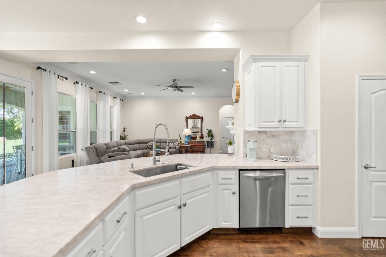 Undisclosed Address Bakersfield, CA 93311 - Photo 12 of 53 a kitchen with a sink dishwasher stove and cabinets
