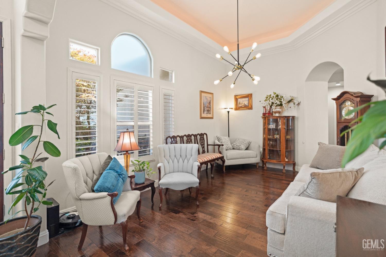 Undisclosed Address Bakersfield, CA 93311 - Photo 16 of 53 a living room with furniture a chandelier and a large mirror
