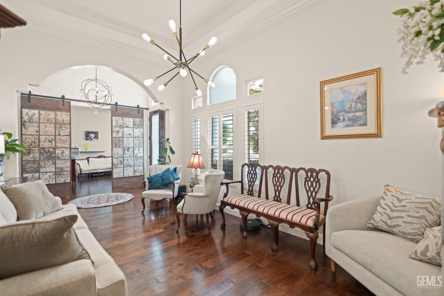 Undisclosed Address Bakersfield, CA 93311 - Photo 20 of 53 a living room with furniture a fireplace and a chandelier