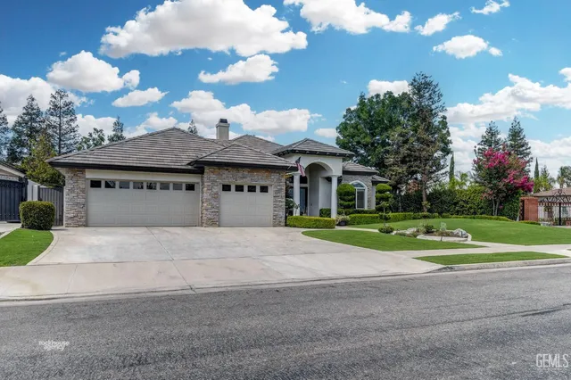 a front view of a house with a yard and entertaining space