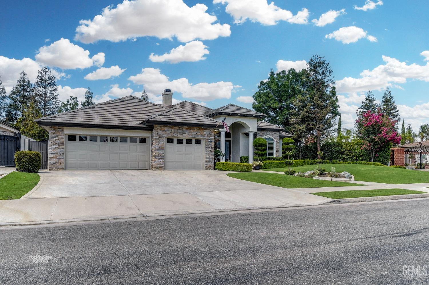 Undisclosed Address Bakersfield, CA 93311 - Photo 2 of 53 a view of yellow house with a big yard and a large trees
