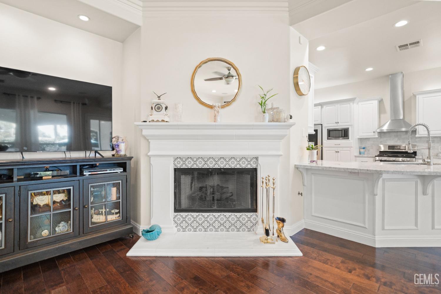 Undisclosed Address Bakersfield, CA 93311 - Photo 25 of 53 a living room with furniture a clock and a fireplace
