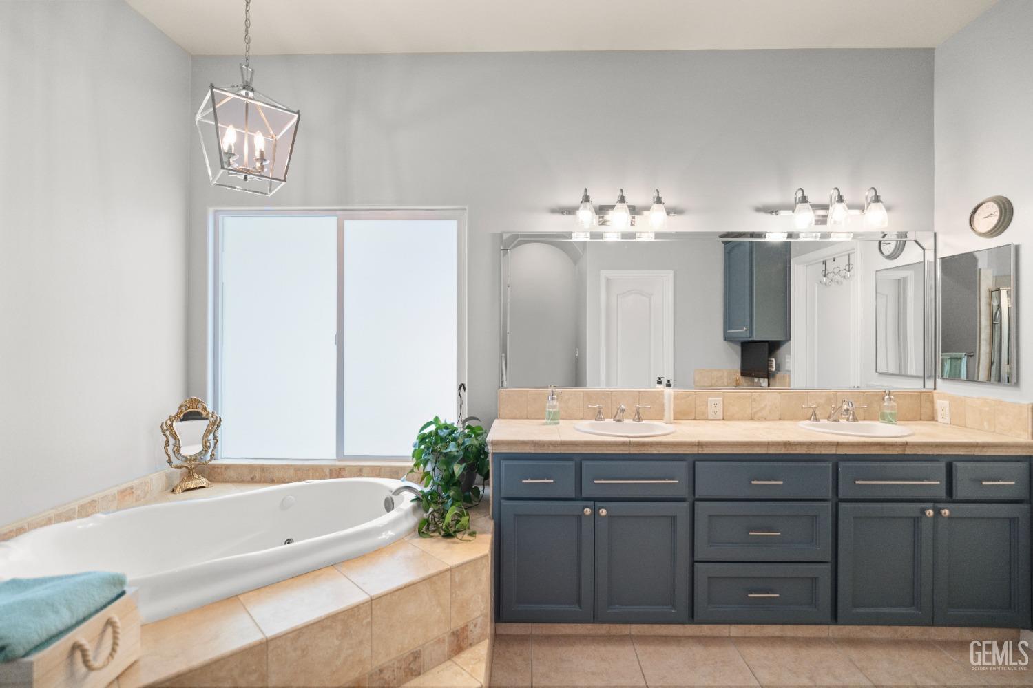 Undisclosed Address Bakersfield, CA 93311 - Photo 29 of 53 a spacious bathroom with a granite countertop sink a mirror and a bathtub