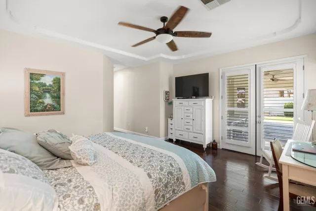 a spacious bedroom with a bed a book shelf and a window