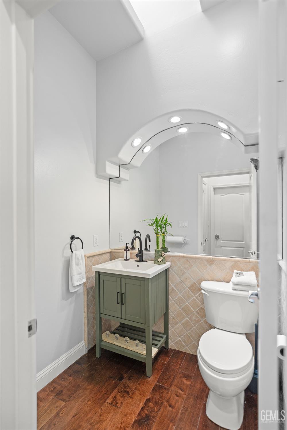 Undisclosed Address Bakersfield, CA 93311 - Photo 35 of 53 a bathroom with a toilet a sink and mirror