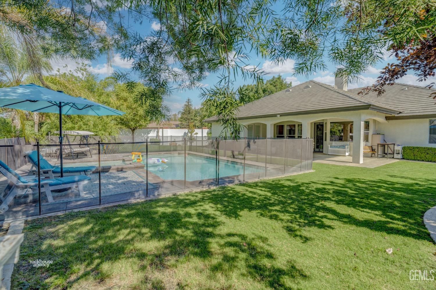 Undisclosed Address Bakersfield, CA 93311 - Photo 41 of 53 a view of a house with a backyard and a patio