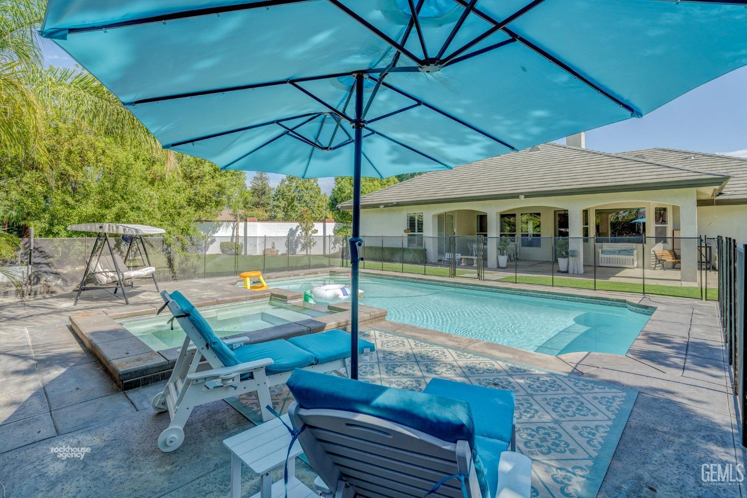 Undisclosed Address Bakersfield, CA 93311 - Photo 43 of 53 a view of pool with lawn chairs under an umbrella