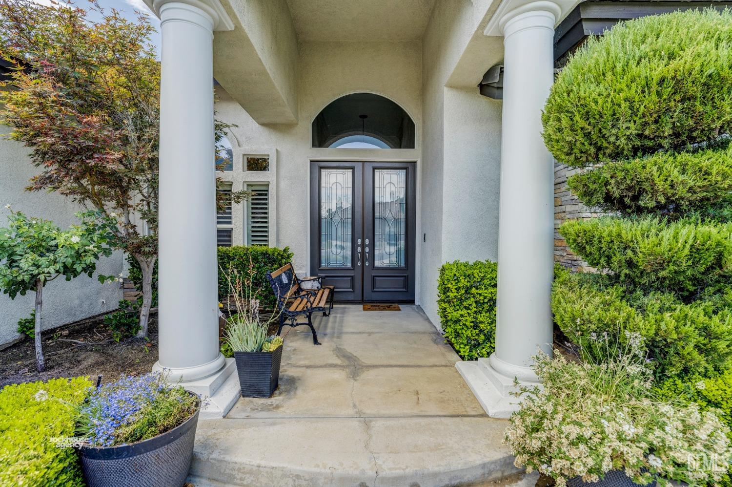 Undisclosed Address Bakersfield, CA 93311 - Photo 53 of 53 a front view of a house with lots of potted plants