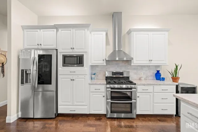 a kitchen with stainless steel appliances a refrigerator sink and cabinets