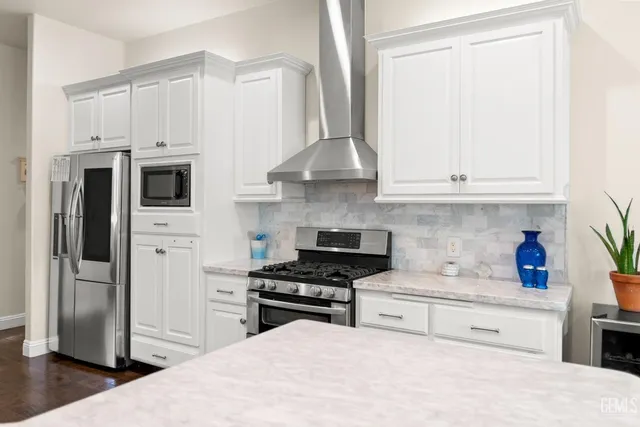 a kitchen with stainless steel appliances white cabinets and a sink