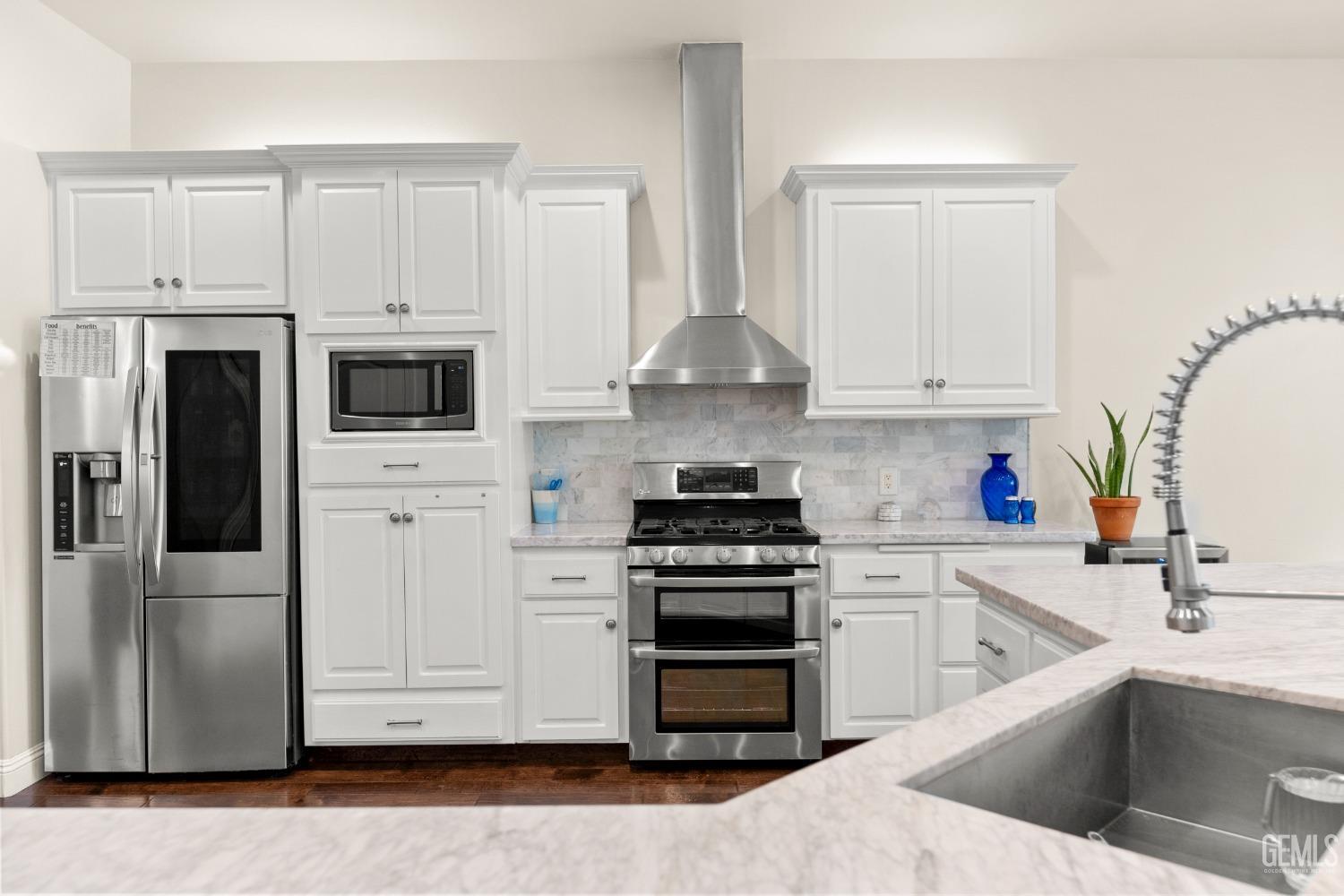 Undisclosed Address Bakersfield, CA 93311 - Photo 8 of 53 a kitchen with stainless steel appliances white cabinets and a sink