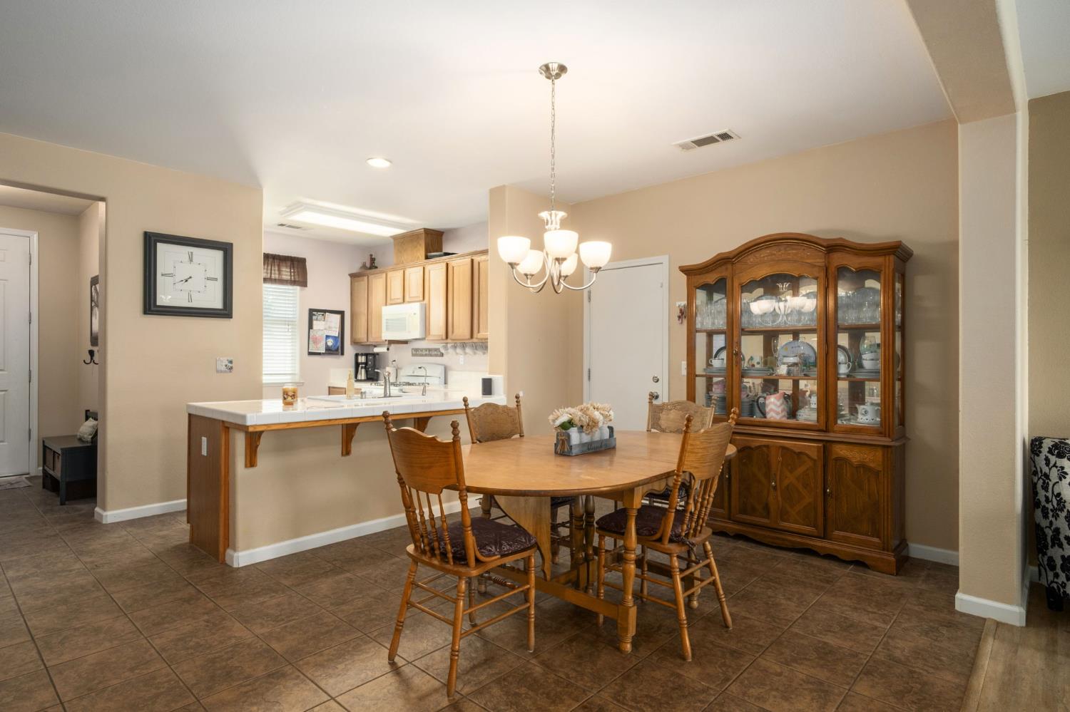 454 Sierra Avenue Reedley, CA 93654 - Photo 12 of 25 a view of a dining room with furniture and chandelier