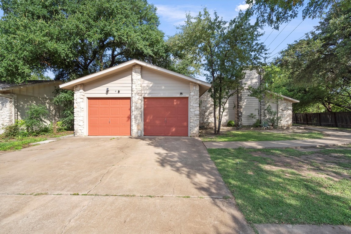 a front view of house with yard and trees
