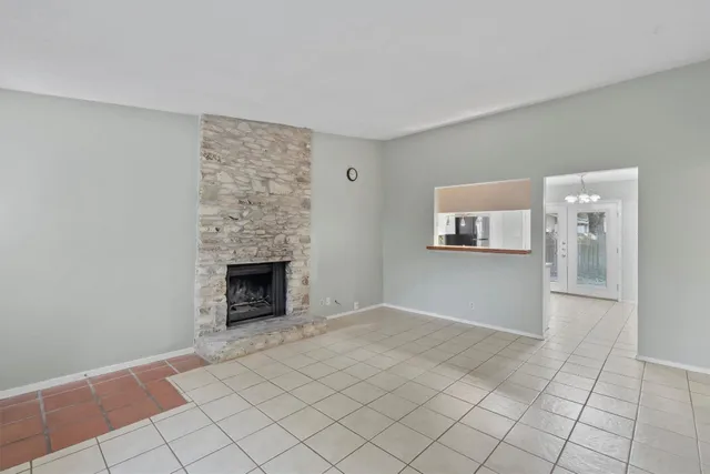 a view of an empty room with a fireplace