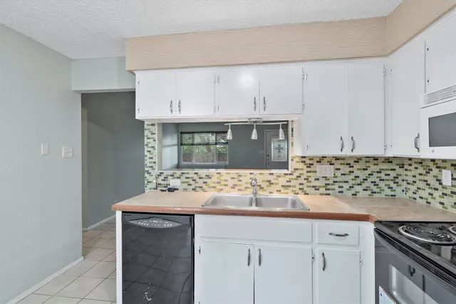 a kitchen with stainless steel appliances granite countertop a sink and cabinets