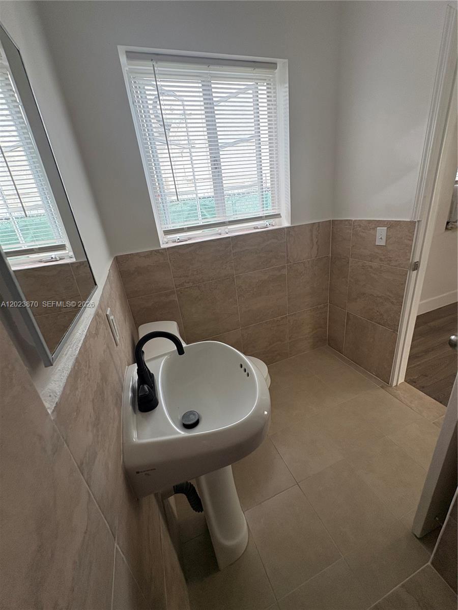 2052 Southwest 7th Street, Unit 4 Miami, FL 33135 - Photo 7 of 10 a bathroom with a sink and a toilet