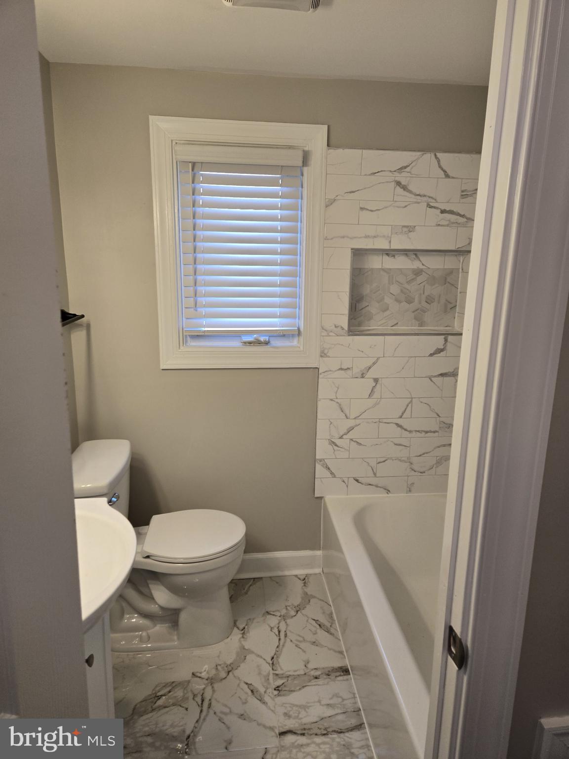 1016 Middleborough Road Essex, MD 21221 - Photo 11 of 33 a bathroom with a toilet and a shower