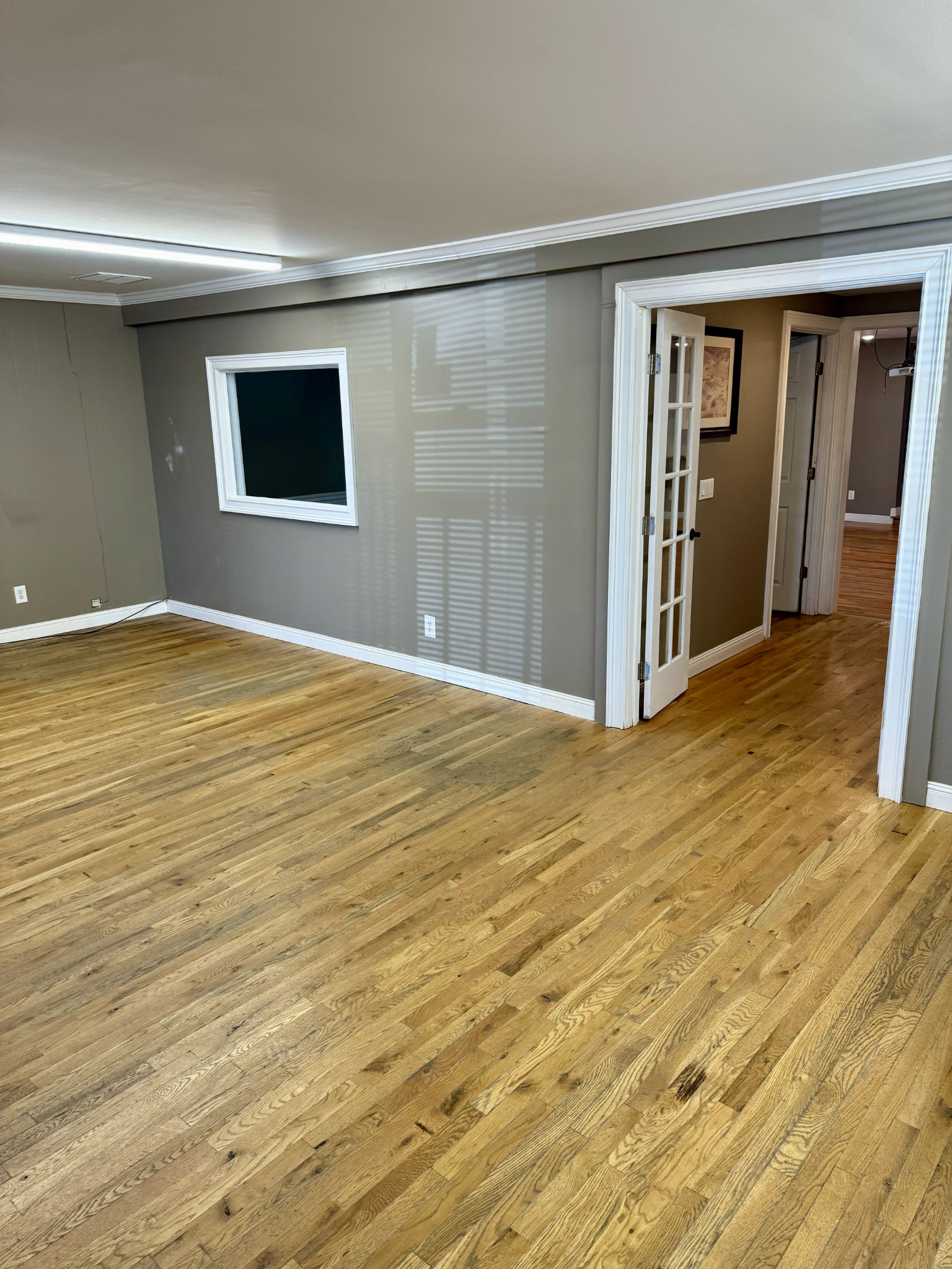 610 West Burton Street Murfreesboro, TN 37130 - Photo 11 of 32 a view of an empty room with wooden floor and a window