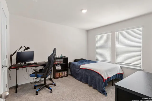 a bedroom with a bed and a desk