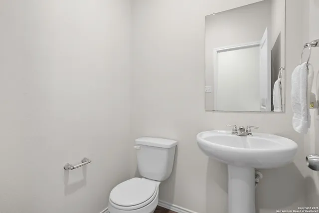 a bathroom with a sink a toilet and mirror