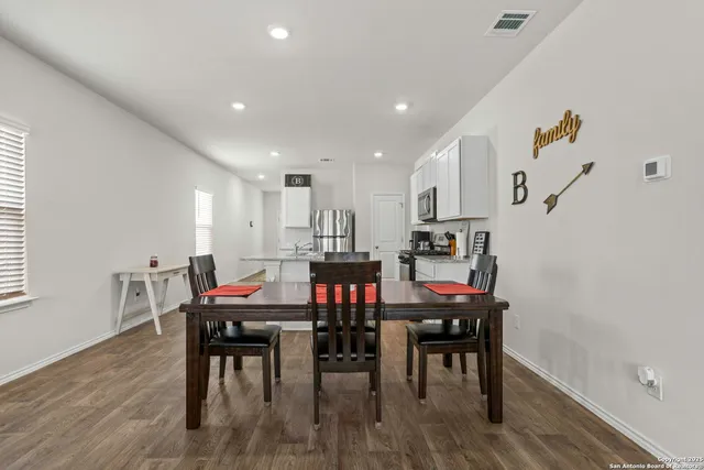 a view of a dining room with furniture and wooden floor
