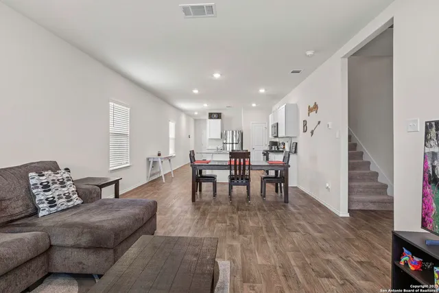 a living room with furniture and wooden floor