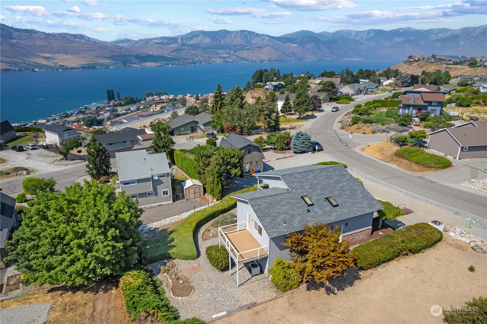 302 Butte Road Chelan, WA 98816 - Photo 11 of 35 an aerial view of a city with lots of residential buildings and mountain view in back