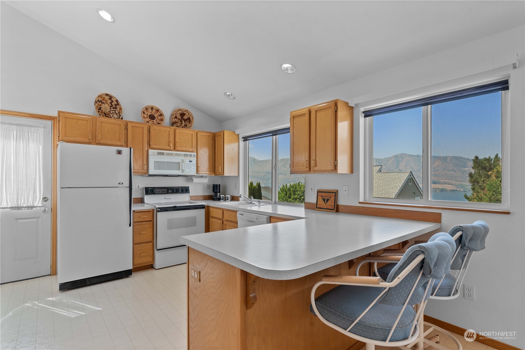 302 Butte Road Chelan, WA 98816 - Photo 10 of 35 a kitchen that has a sink a stove and a refrigerator