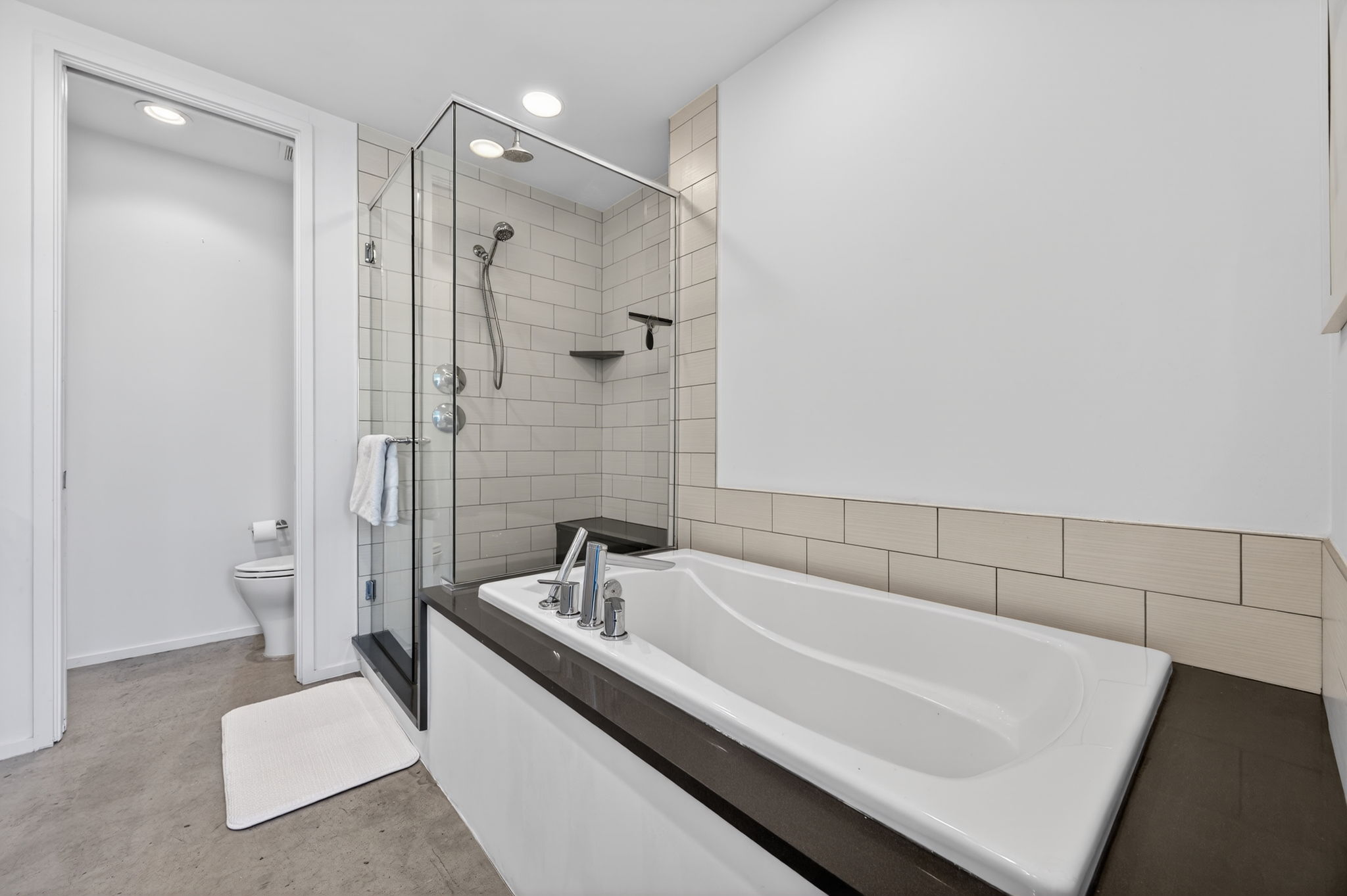 2301 South 5th Street, Unit 25 Austin, TX 78704 - Photo 18 of 35 Full bath with a bath, a stall shower, and concrete floors
