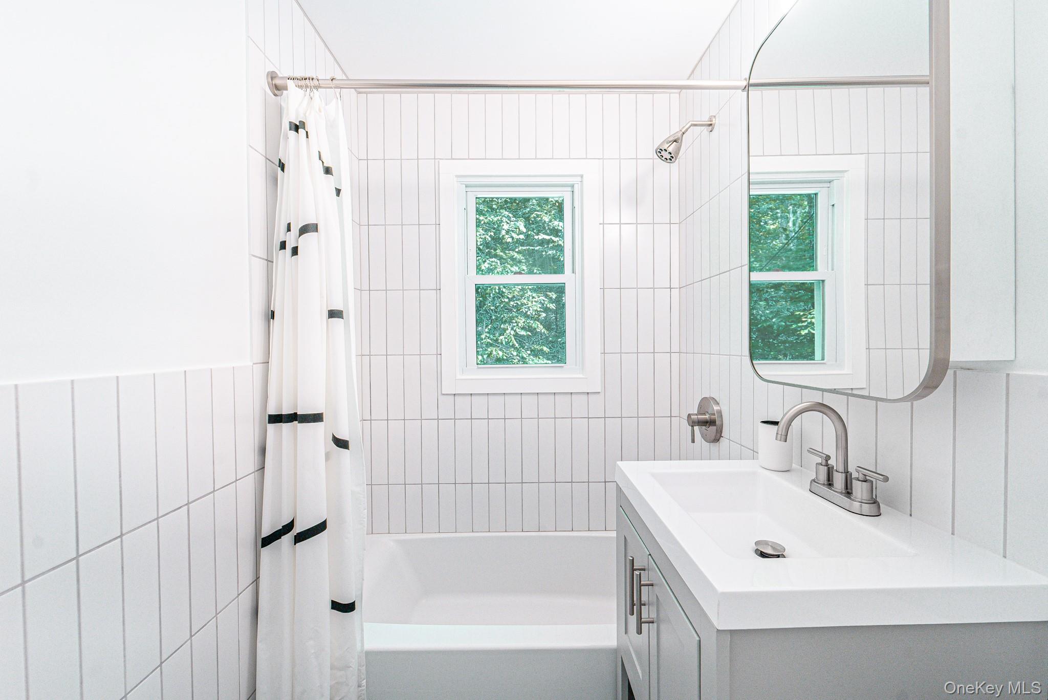 9 Higgins Trail Monroe, NY 10950 - Photo 21 of 24 a bathroom with a sink a mirror and a shower