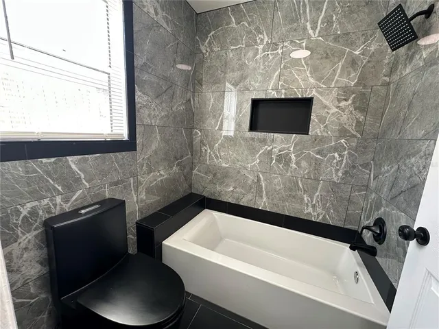 a bathroom with a toilet bathtub and sink