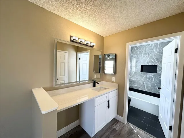 a en suite bathroom with a sink and a mirror