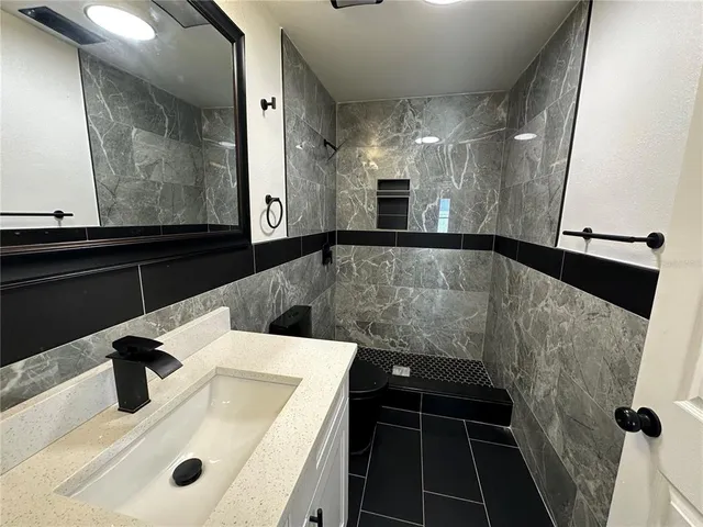 a view of a bathroom with a sink and mirror
