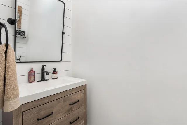 a bathroom with a sink and a mirror
