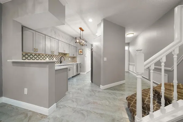 a view of a kitchen cabinets and chandelier
