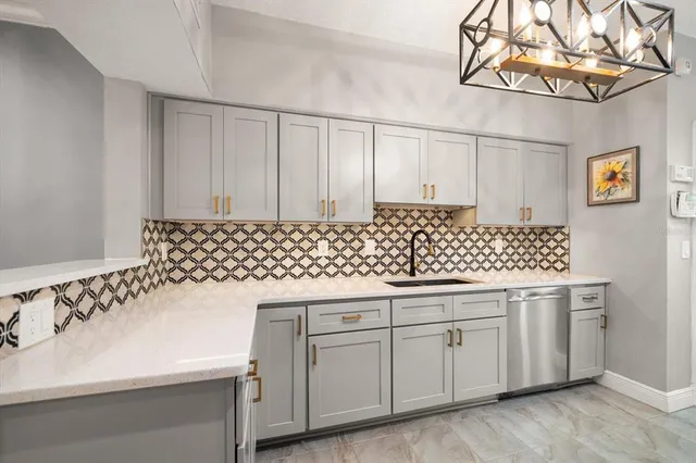 a kitchen with granite countertop white cabinets and white appliances
