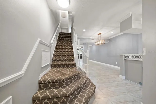 a spacious bedroom with a bed and a flat screen tv