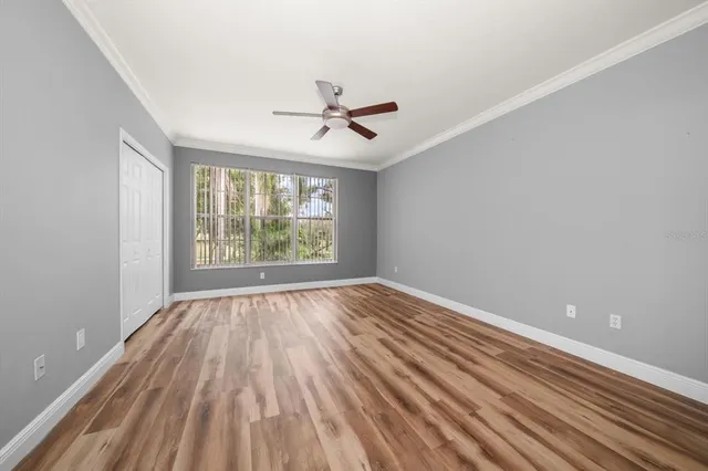 a view of a room with wooden floor and white walls
