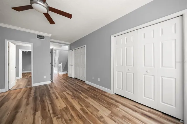 a bathroom with a granite countertop sink a mirror and shower
