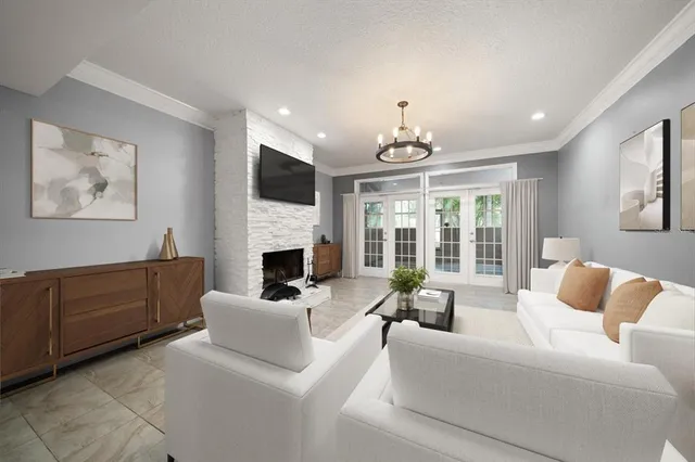 a living room with furniture fireplace and a large window