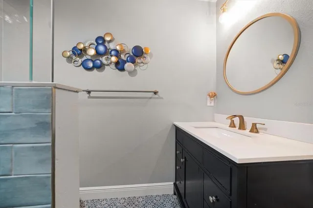 a spacious bedroom with a large bed and a chandelier